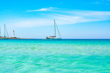 Crystal clear light blue water on sandy beach San Vito lo Capo, Sicily, Italy