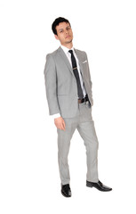 Young business man standing relaxed in a gray suit