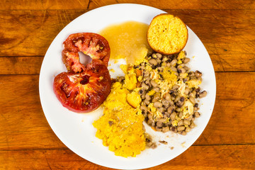 Soul Food Vegetable Plate with Squash and Ripe Tomato and Cornbread crumbled in Black eyed Peas and Apple Sauce