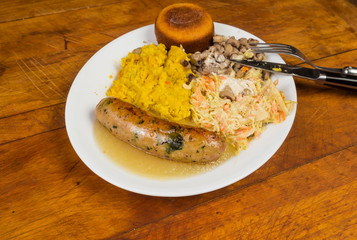 Smoked Chicken, Spinach and Feta Cheese Sausage in Apple Sauce with Vegetables and Coleslaw in Rustic Setting