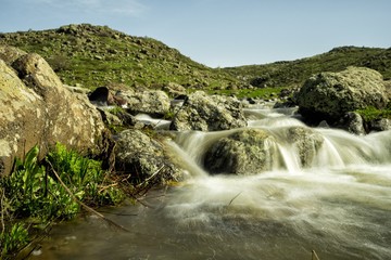 Waterfalls on a mountain stream. A delightful spring landscape. Mount Aragats. Armenia