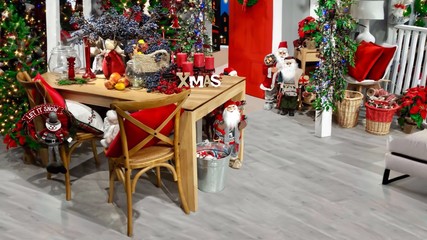 Beautiful Christmas home interior decoration with a fir, colorful lights and Santa Claus figures 