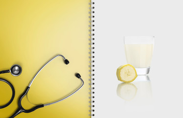 concept of balanced medical diet with healthy food, paper notebook pages with stethoscope, and...