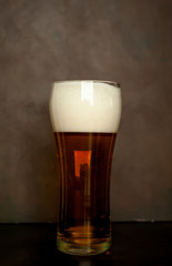 glass of fresh beer on a stone background