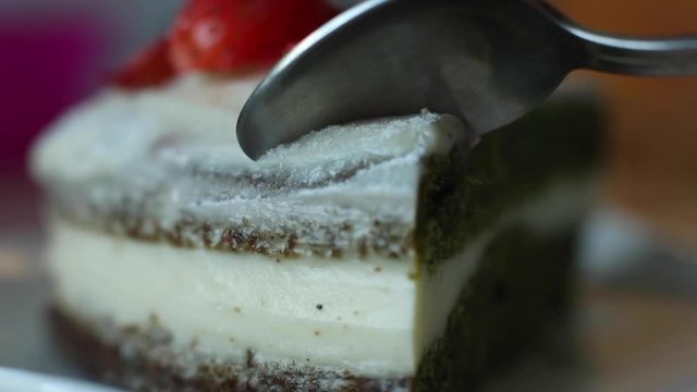 utting piece of appetizing fresh biscuit pastry cake with strawberry jam extreme close-up. Amazing tasty dessert food using fork and knife enjoying beautiful serving dishes macro shot