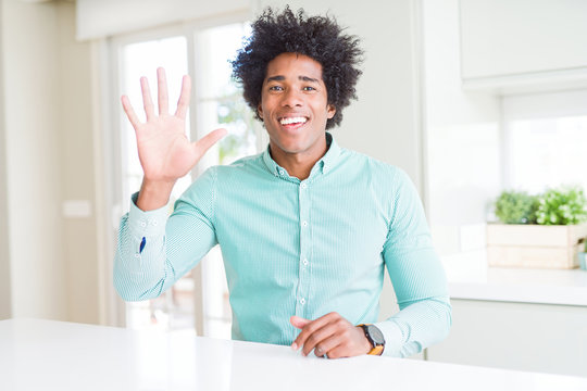African American business man wearing elegant shirt showing and pointing up with fingers number five while smiling confident and happy.