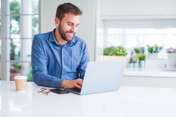 Fototapeta premium Handsome business man working using computer laptop and smiling
