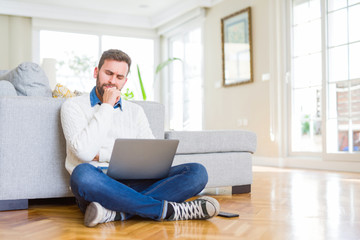 Handsome man wearing working using computer laptop serious face thinking about question, very...