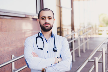 Closeup portrait of professional male asian medical student. People - a doctor, a nurse and a surgeon on the background of the university's educational clinic. Health insurance. Medical Education