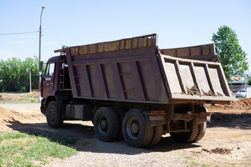 Dump truck At the construction site. Vehicles for the transport of materials.