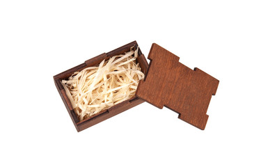 Open wooden box with filling material inside. Empty natural wooden box with decorative straw for happy gifts.