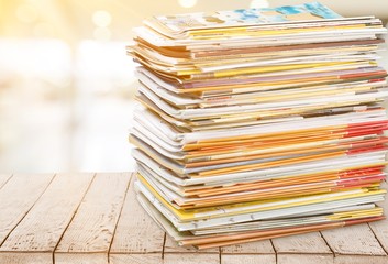 Pile of newspapers on white background