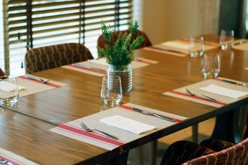 casual restaurant dining table set up, with dark brown color theam