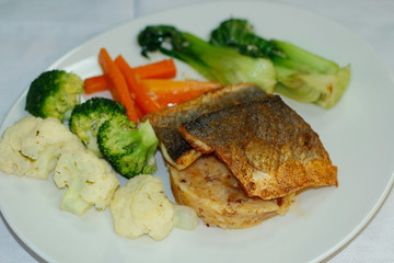 pan siered sea bass fillet with mashed potatoes and steamed vegetables