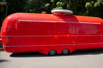 Red retro van. Shop on wheels. House on wheels . Trade in the city park.