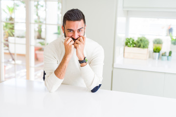 Handsome man smiling cheerful with a big smile on face showing teeth, positive and happy expression
