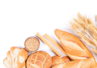 different kinds of bread with wheat and ears on a white background