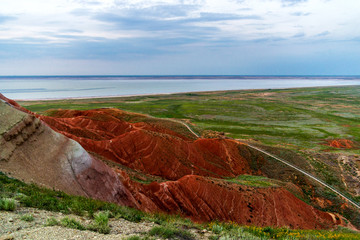 Big Bogdo mountain. Red sandstone outcrops on the slopes sacred mountain in Caspian steppe Bogdo - Baskunchak nature reserve, Astrakhan region, Russia.