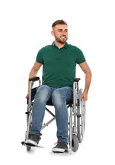 Handsome young man in wheelchair isolated on white
