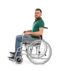 Handsome young man in wheelchair isolated on white