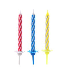Color birthday cake candles on white background