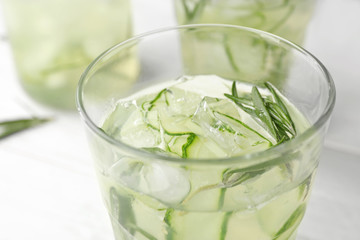 Glass of refreshing cucumber lemonade on table, closeup. Summer drink