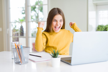 Beautiful young girl studying for school using computer laptop screaming proud and celebrating victory and success very excited, cheering emotion