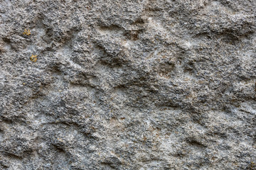 Background and texture of old gray stone wall, close up and full frame
