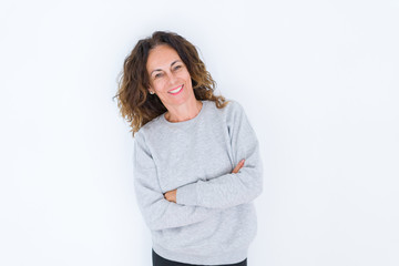 Beautiful middle age woman with curly hair smiling cheerful and happy with arms crossed, laughing with a big smile on face showing teeth over white isolated background