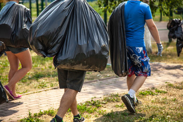 Garbage collection. Separate garbage collection worldwide. Recycling. Household waste. Elimination of illegal dumps. People cleaned the street. Big bags. - Powered by Adobe