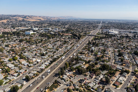Aerial view of streets, buildings and traffic along the 880 freeway near Hayward, San Leandro and Oakland, California.