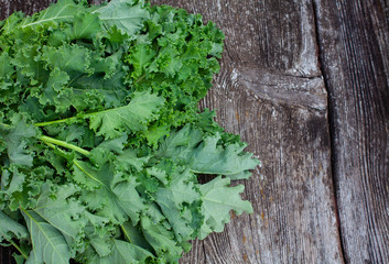 fresh kale cabbage on wooden surface