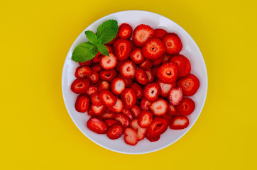 strawberries on a yellow background with mint