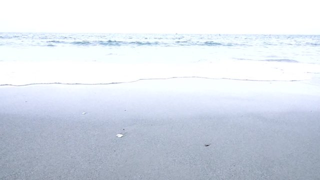 Slow motion video of sea waves hitting the beach shore