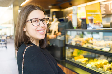 Beautiful young woman smiling at the town