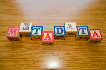 Educational toy cubes with letters organised to display word metadata - keywording and Search engine optimisation concept