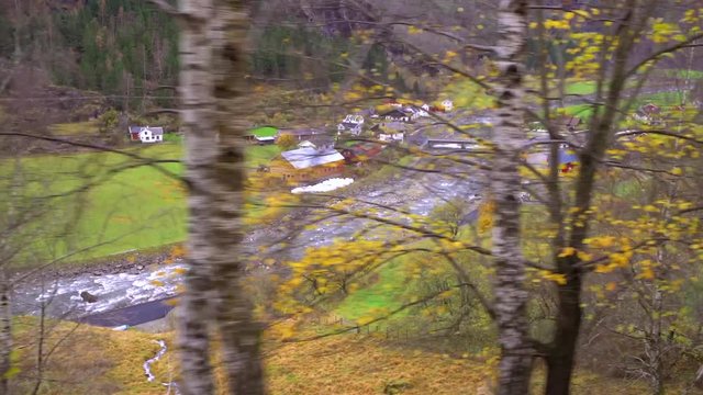 View of the mountain valley and village Flam as seen from the scenic Flamsbana train line running between Flam and Myrdal as a part of Norway in a nutshell tour, Norway