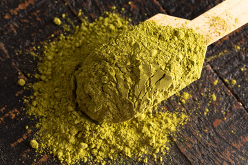 A Scoop of Green Tea Matcha Powder on a Woodn Table