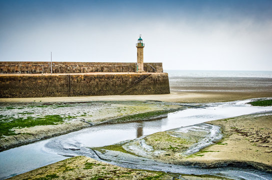 Binic, France - June, 27, 2012. Lighthouse in port without water at low tide