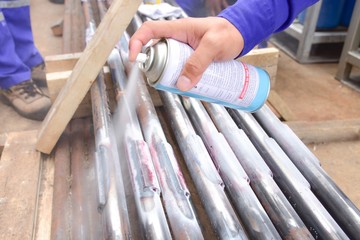 Penetrant Test , worker apply developer to the welding of  workpiece for finding the defect.