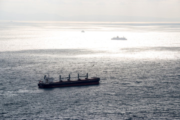A large cargo ship passing through the straight of Gibraltar