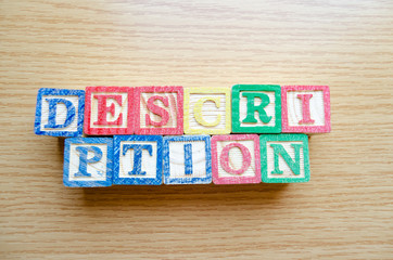 Educational toy cubes with letters organised to display word DESCRIPTION - editing metadata and...