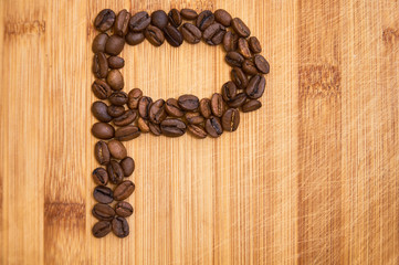 Alphabet letter P made from roasted coffee beans, 3D rendering on wooden table background
