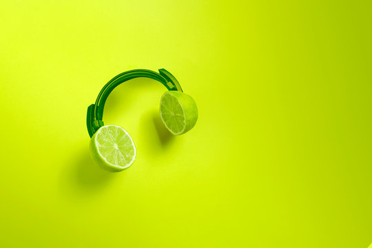Green citrus headphones. Creative concept for summer parties. 