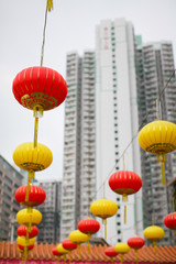 Red and yellow Chinese lanterns on a background of white skyscrapers. concept of contrast of old traditions and modern world.