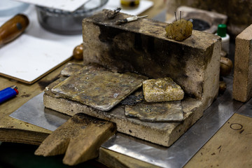 Close up of a wooden work bench for precious metal cultivation with several inflammable surface materials 