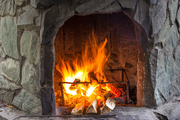 burning fire in a stone oven. fire on wood in the oven. fireplace