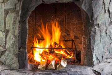 burning fire in a stone oven. fire on wood in the oven. fireplace