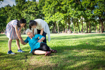 Asian elderly woman with walking stick on floor after falling down,caregiver, assistant or...
