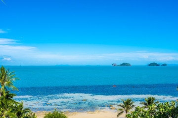 Beautiful tropical sea ocean with coconut palm tree on blue sky white cloud